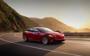 Tesla Approved Body Shop - Tesla Sedan Driving on Canyon Road